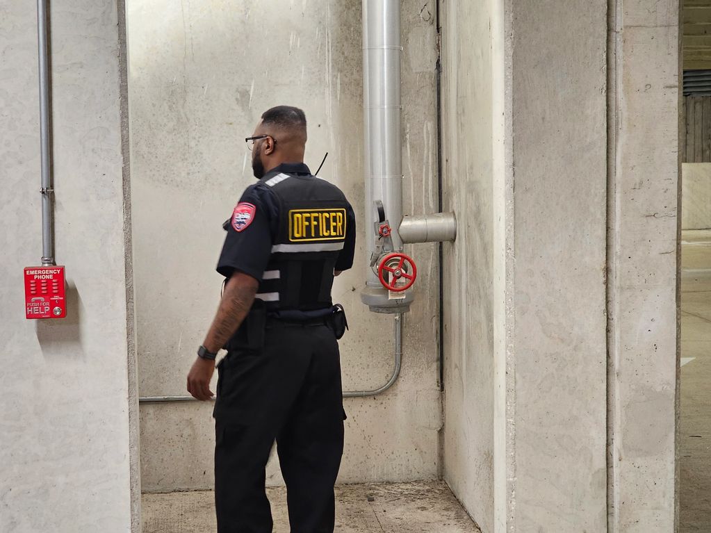 A licensed security guard in Houston checking a building during a patrol
